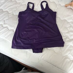 Purple one piece swimsuit. Small skirt in the front.